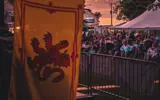 A Scottish flag in the foreground of an audience at Kincardine's Scottishfest.