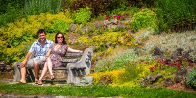 A couple sit on a bench in Kincardine's Rock Garden.